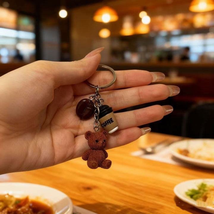 Playful cartoon bear with beverage keychain charm. Adorable animal accessory for bags, keys, or fun gift.