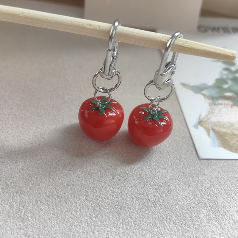 Vibrant red plastic tomato keychain for bags & keys, a fun and unique accessory.