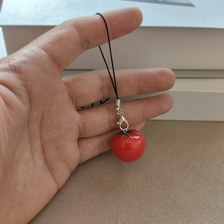 Playful tomato fruit keychain, a unique and cute bag accessory or key holder.
