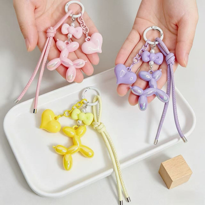 Adorable heart and balloon dog shaped keychain charm, perfect for keys or bags.