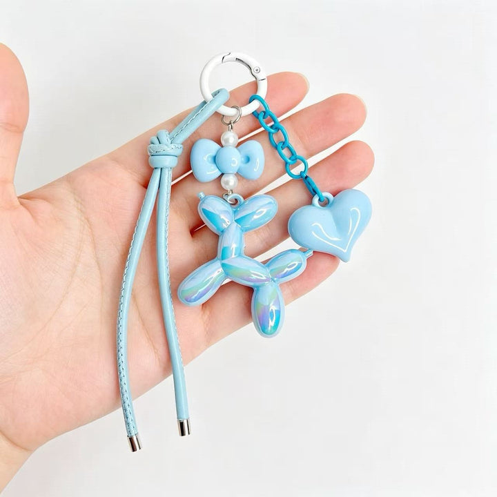 Brightly colored resin heart and balloon dog keychain, a fun and durable bag charm.