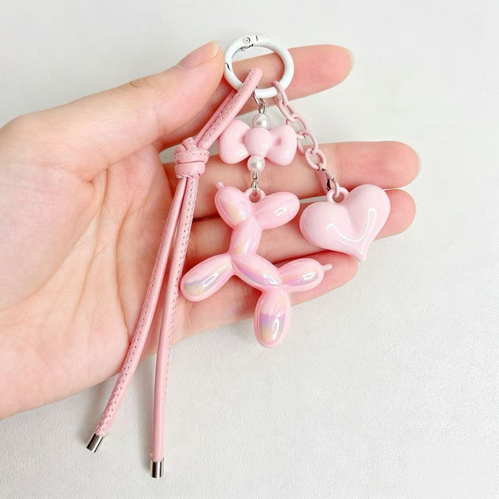 Whimsical resin balloon dog & heart charm, a cute accessory for keyrings or zippers.