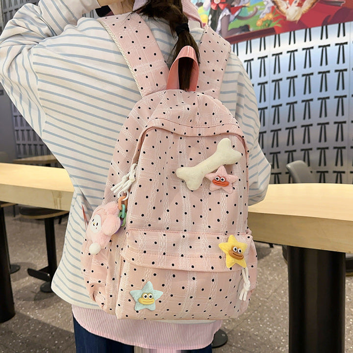 Cute women's pink polka dot backpack for school or casual outings. Stylish and spacious fashion bag.