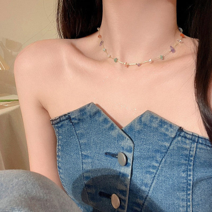 Close-up of a delicate multi-color beaded chain necklace, showcasing fine craftsmanship.