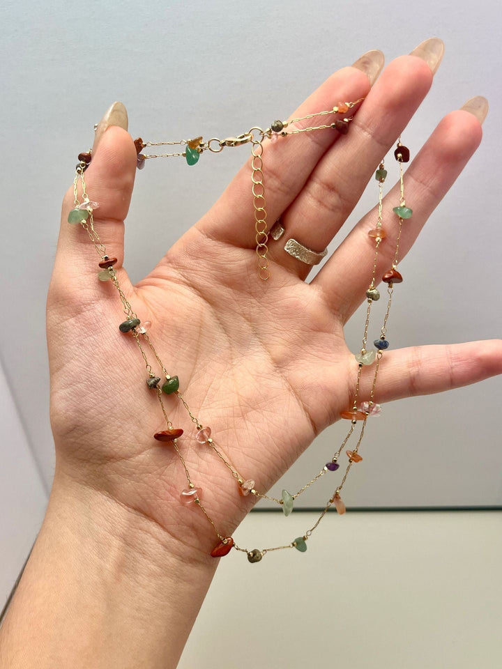 Women's minimalist jewelry: delicate beaded chain necklace with subtle multi-color accents.