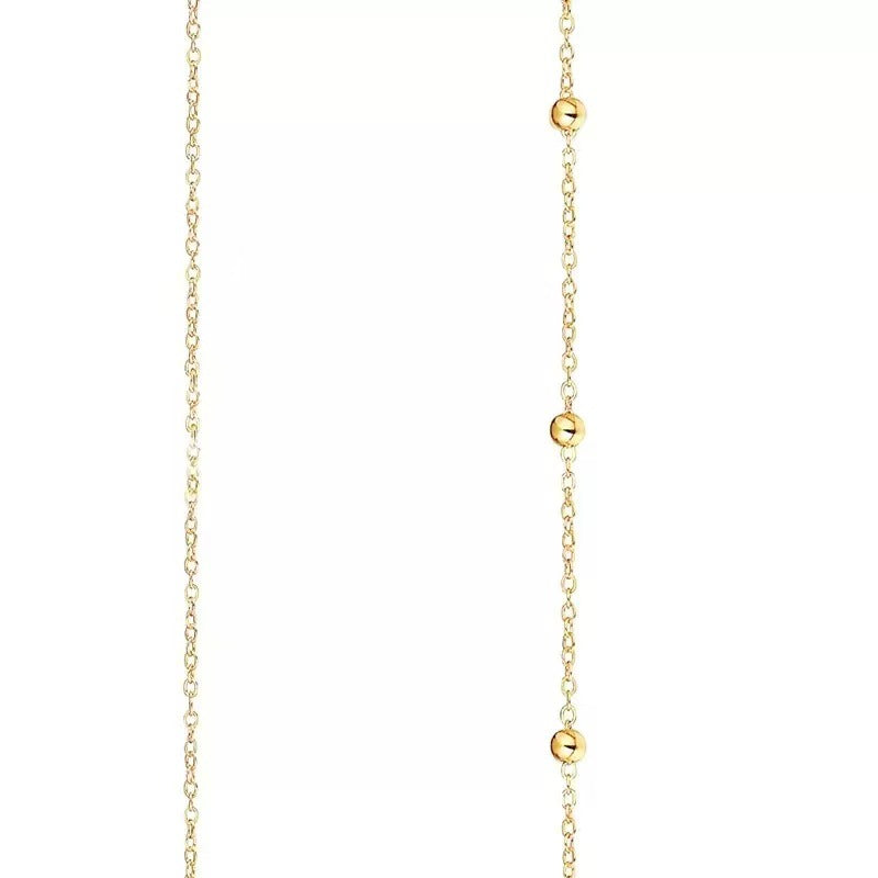Close-up of a beautiful gold dainty layered chain necklace, highlighting its delicate design and elegant style.