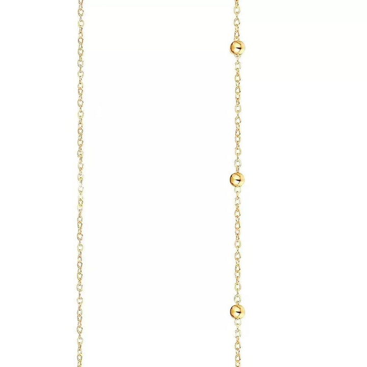 Close-up of a beautiful gold dainty layered chain necklace, highlighting its delicate design and elegant style.