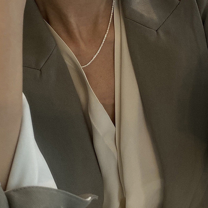 Elegant gold-tone dainty textured chain necklace. Women's minimalist accessory, perfect for layering or solo wear.