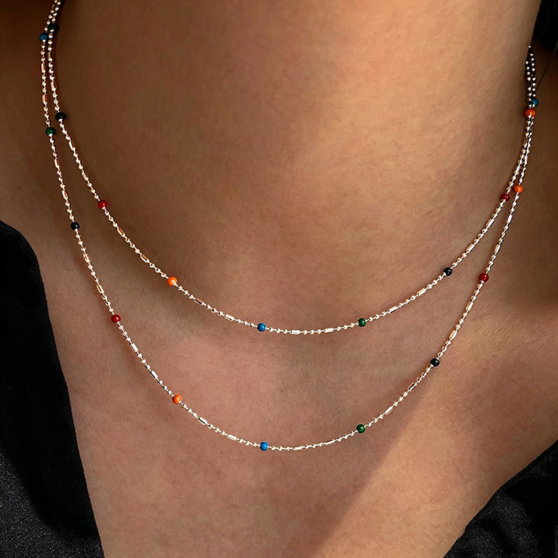 Dainty multi-colored beaded chain bracelet for women, adjustable & elegant fashion accessory.