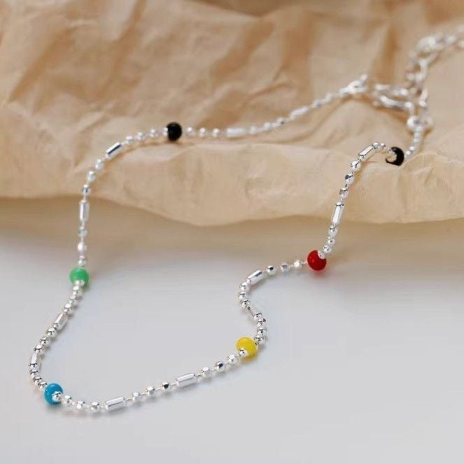 Adjustable multi-colored beaded chain bracelet, a dainty & versatile women's fashion jewelry for vibrant style.