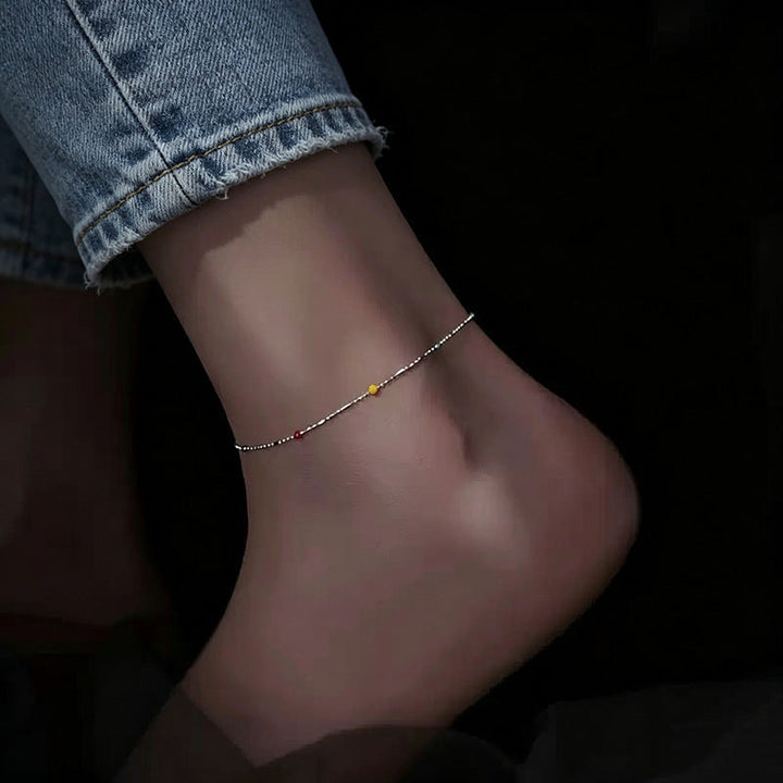 Women's multi-colored beaded chain bracelet, dainty & stylish, featuring an adjustable chain for comfort.