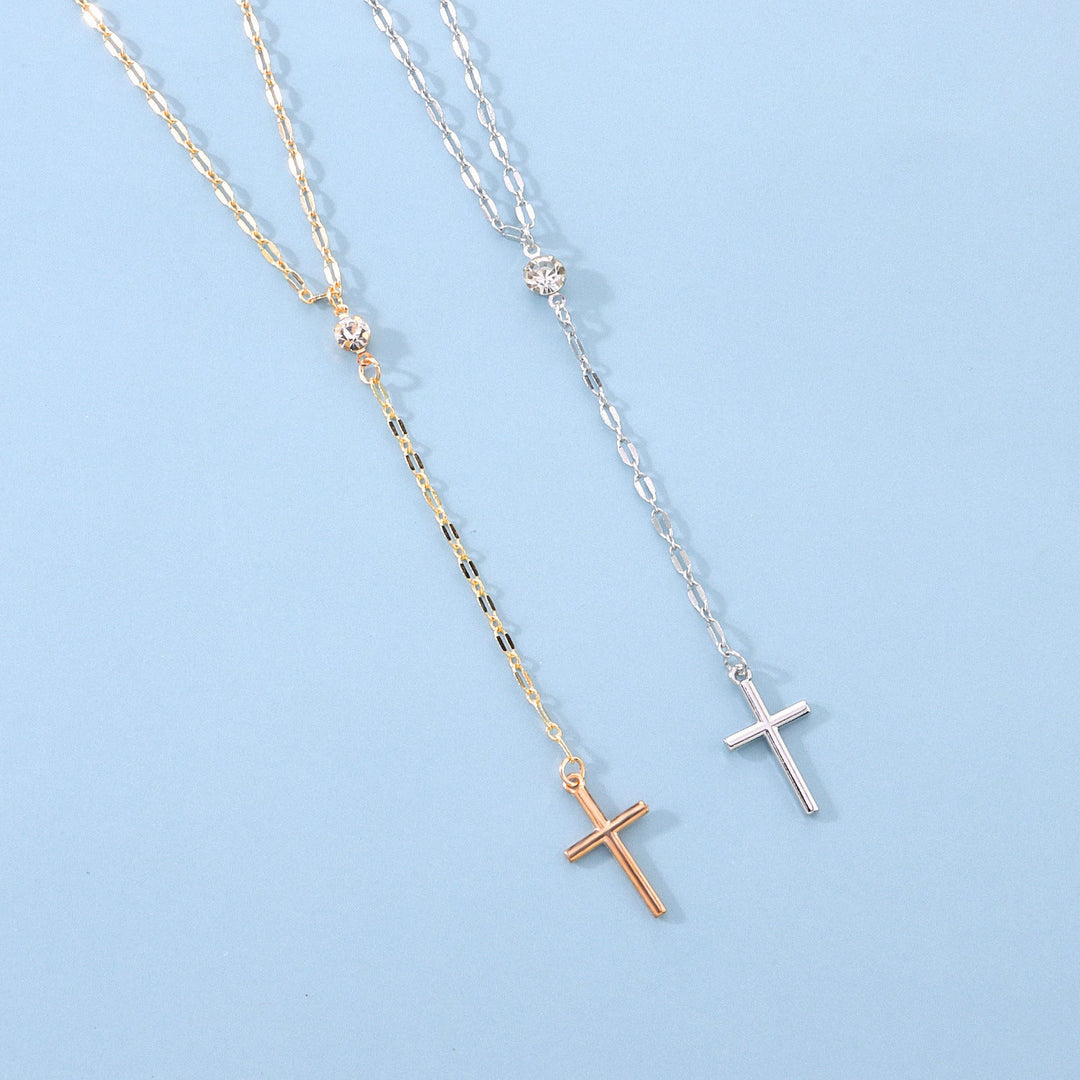 Delicate women's lariat necklace with a small cross, elegant spiritual fashion accessory.