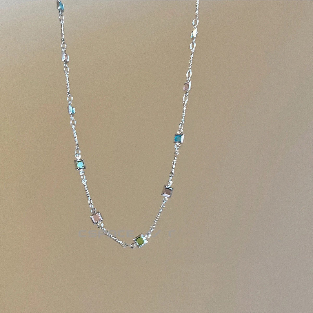 Fashionable dainty gold link chain necklace, colorful and elegant women's jewelry accessory.