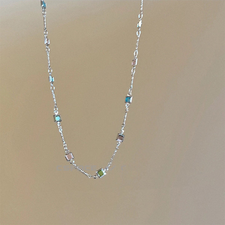 Fashionable dainty gold link chain necklace, colorful and elegant women's jewelry accessory.