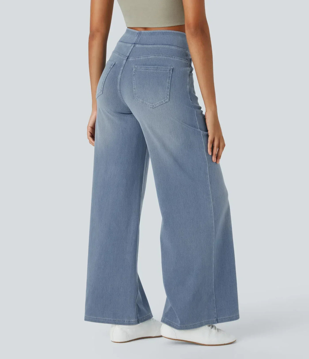 Back view of light blue wide-leg stretch trousers, showing comfortable high-waisted fit.