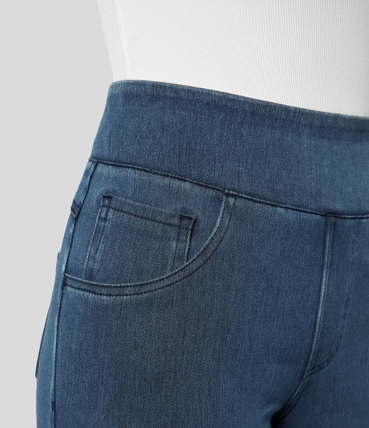 Model wearing dark blue high-waisted wide-leg stretch trousers, showing casual comfort.