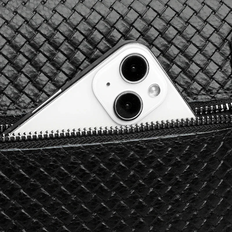 Men's compact leather sling bag holding phone & wallet, perfect for everyday carry.
