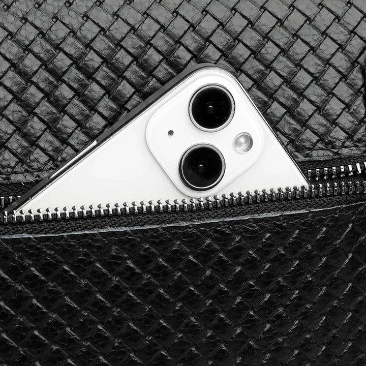 Men's compact leather sling bag holding phone & wallet, perfect for everyday carry.