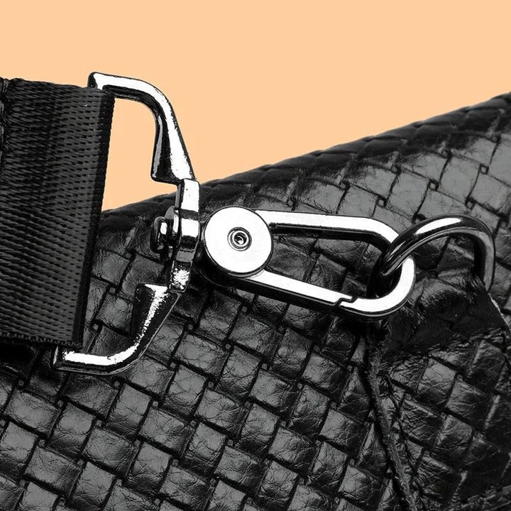 Smooth, durable zipper detail on a men's stylish leather crossbody bag.