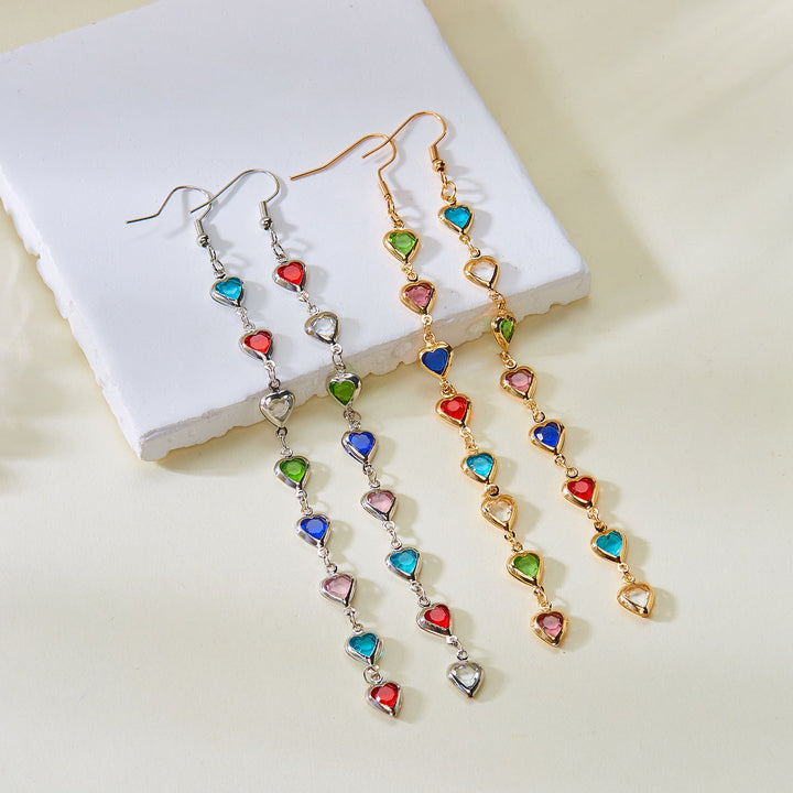 Women's sparkling heart drop earrings. Elegant dangling fashion jewelry with a dazzling white finish.