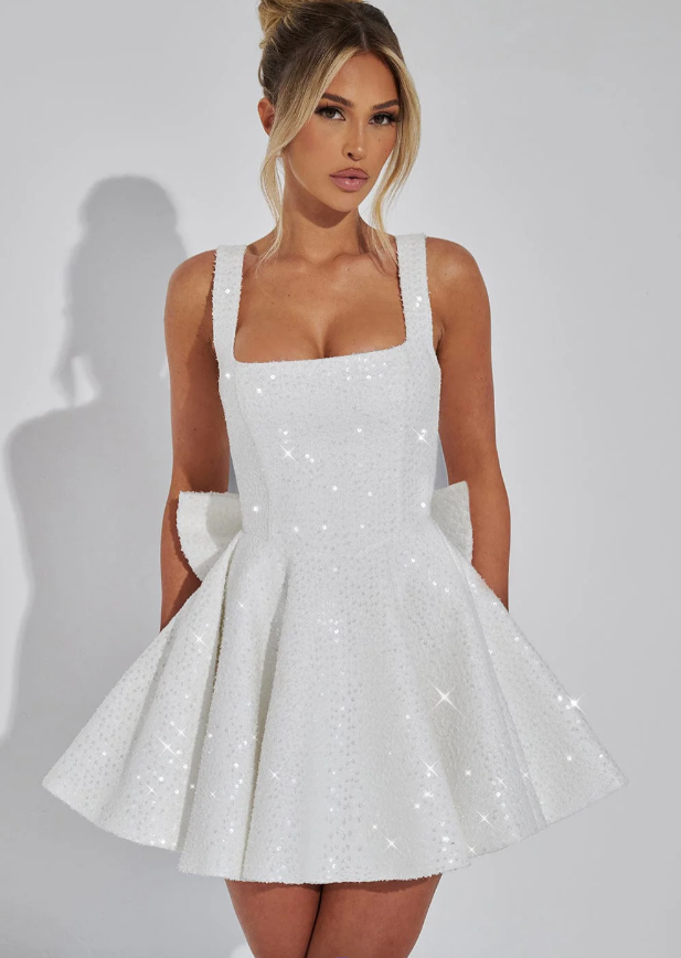 Sleeveless sequin mini dress with a dazzling bow. Elegant women's fashion, perfect for evening wear & parties.
