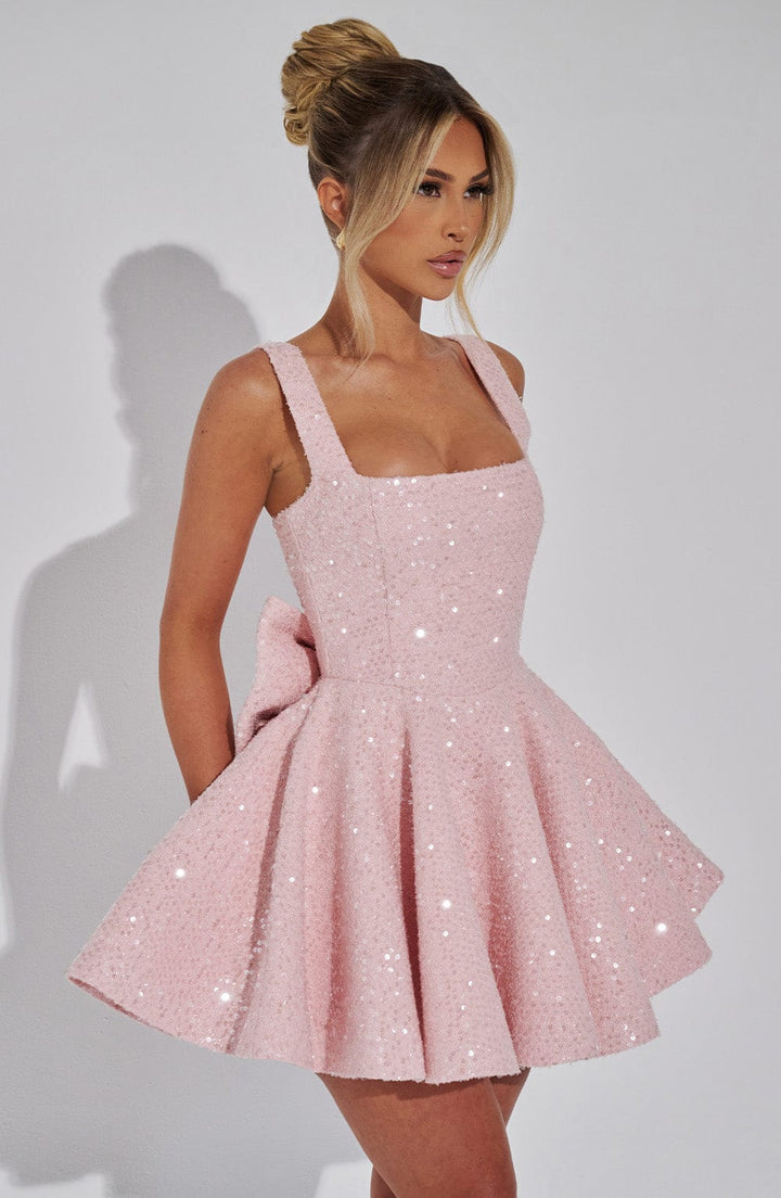 Stylish sleeveless mini dress featuring a prominent bow and dazzling sequins. Ideal women's party fashion.