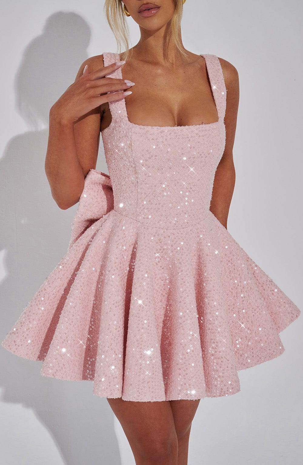 Elegant white sequin mini dress with a chic bow. Dazzling women's cocktail party & special occasion wear.