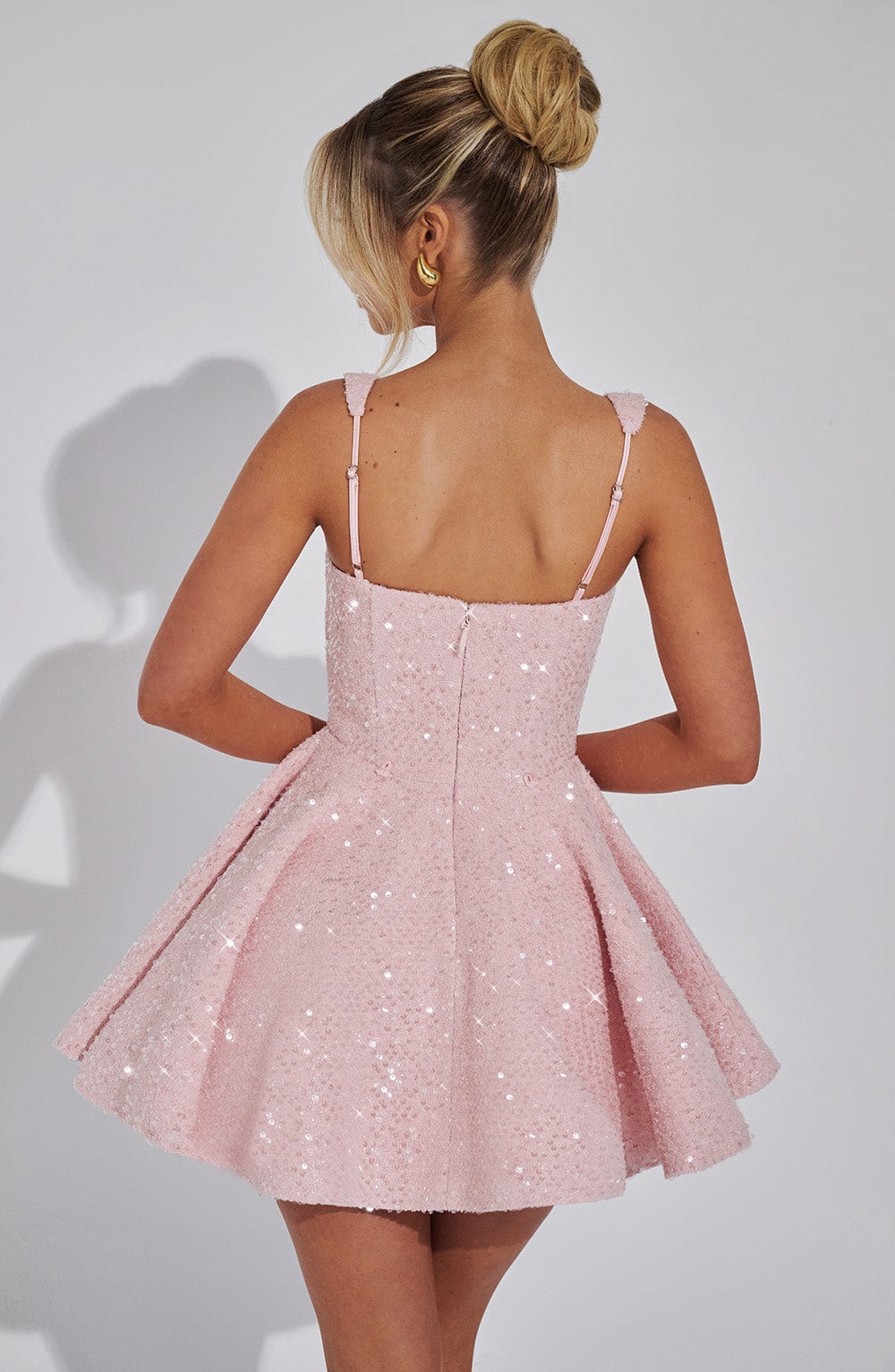 Front view of a dazzling sequin bow mini dress. Perfect sleeveless party dress for women's special occasions.