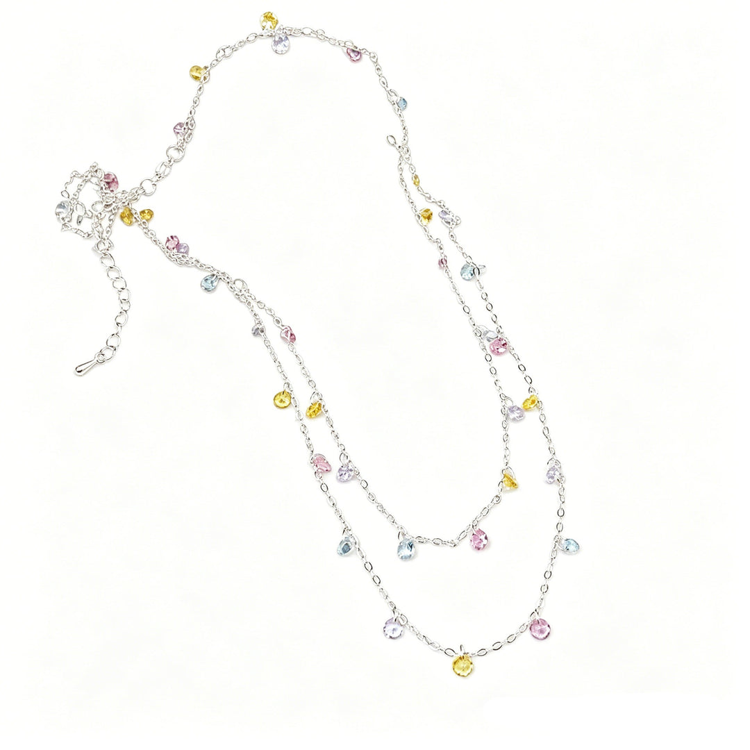 Dazzling women's silver ankle bracelet with multiple charms, an elegant fashion accessory.