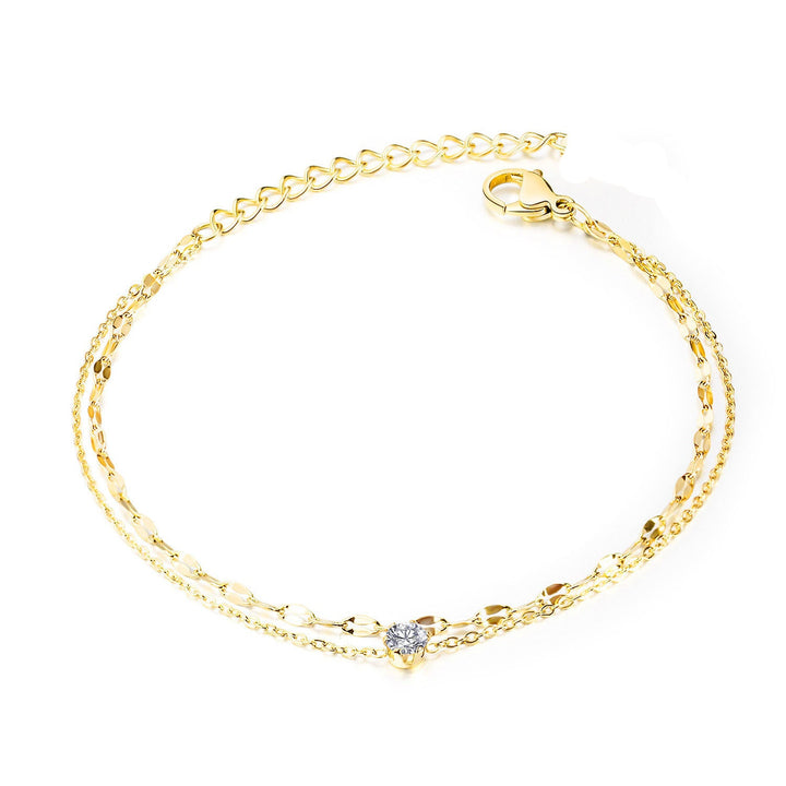 Women's delicate gold double strand anklet, a beautiful summer accessory for elegant foot jewelry.