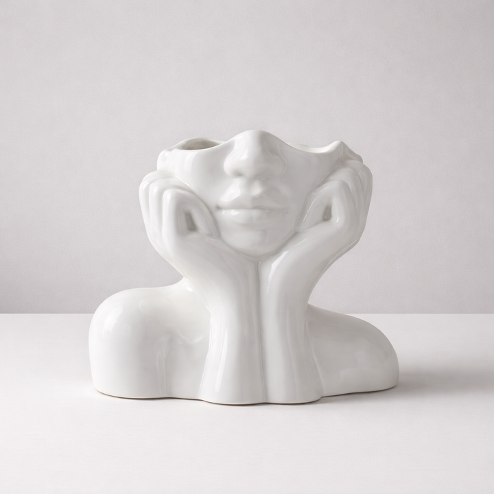Decorative ceramic face vase, an artistic sculpture for modern home decor. Unique interior design accent.