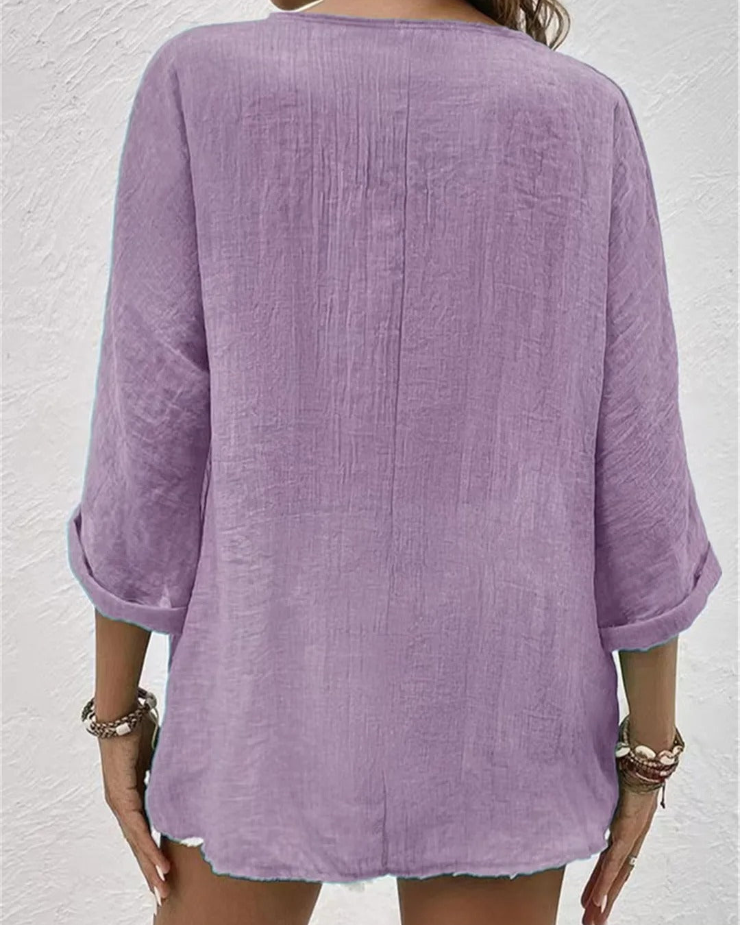 Lightweight women's v-neck button-down blouse with rolled sleeves, ideal for versatile summer fashion.