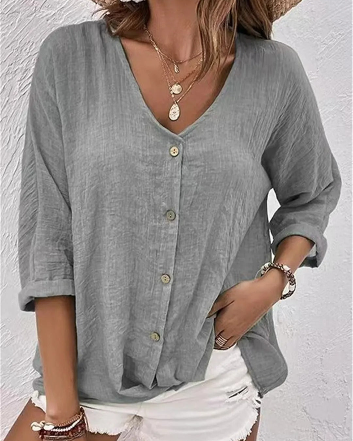 Women's summer blouse: breathable fabric, deep v-neck, button-down front, stylish rolled sleeves.