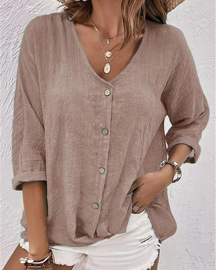 Versatile women's top: deep v-neck, full button-down, rolled sleeves. Perfect lightweight casual wear.