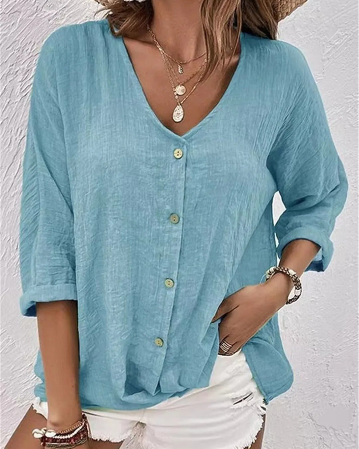 Women's casual button-down blouse, deep v-neck, and practical rolled sleeves. Essential summer wardrobe.