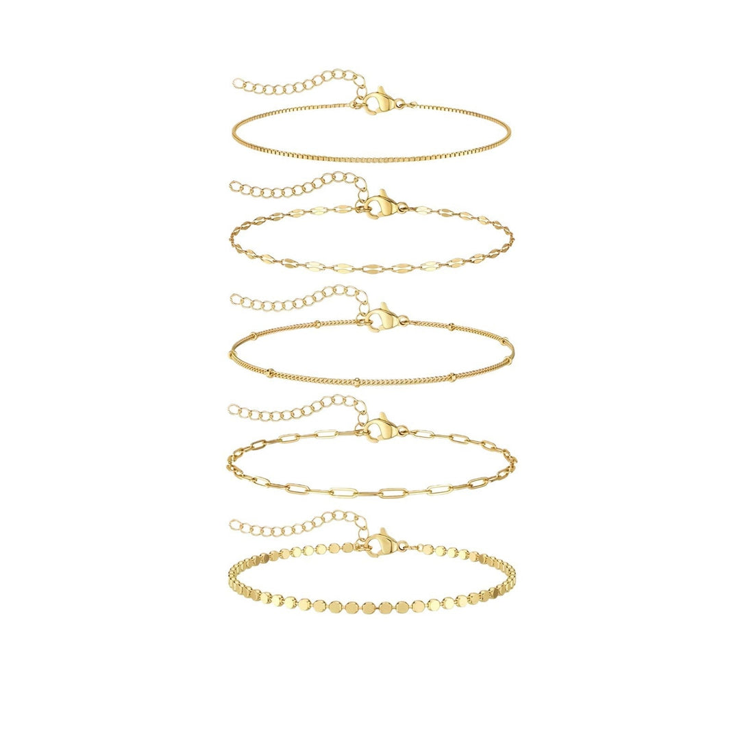 Stackable delicate gold chain bracelet set. Women's elegant fashion accessory, perfect for layering.