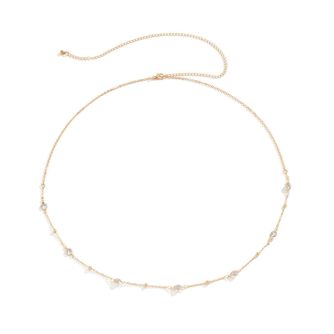 Close-up of a women's delicate beaded gold chain necklace, showcasing intricate design.