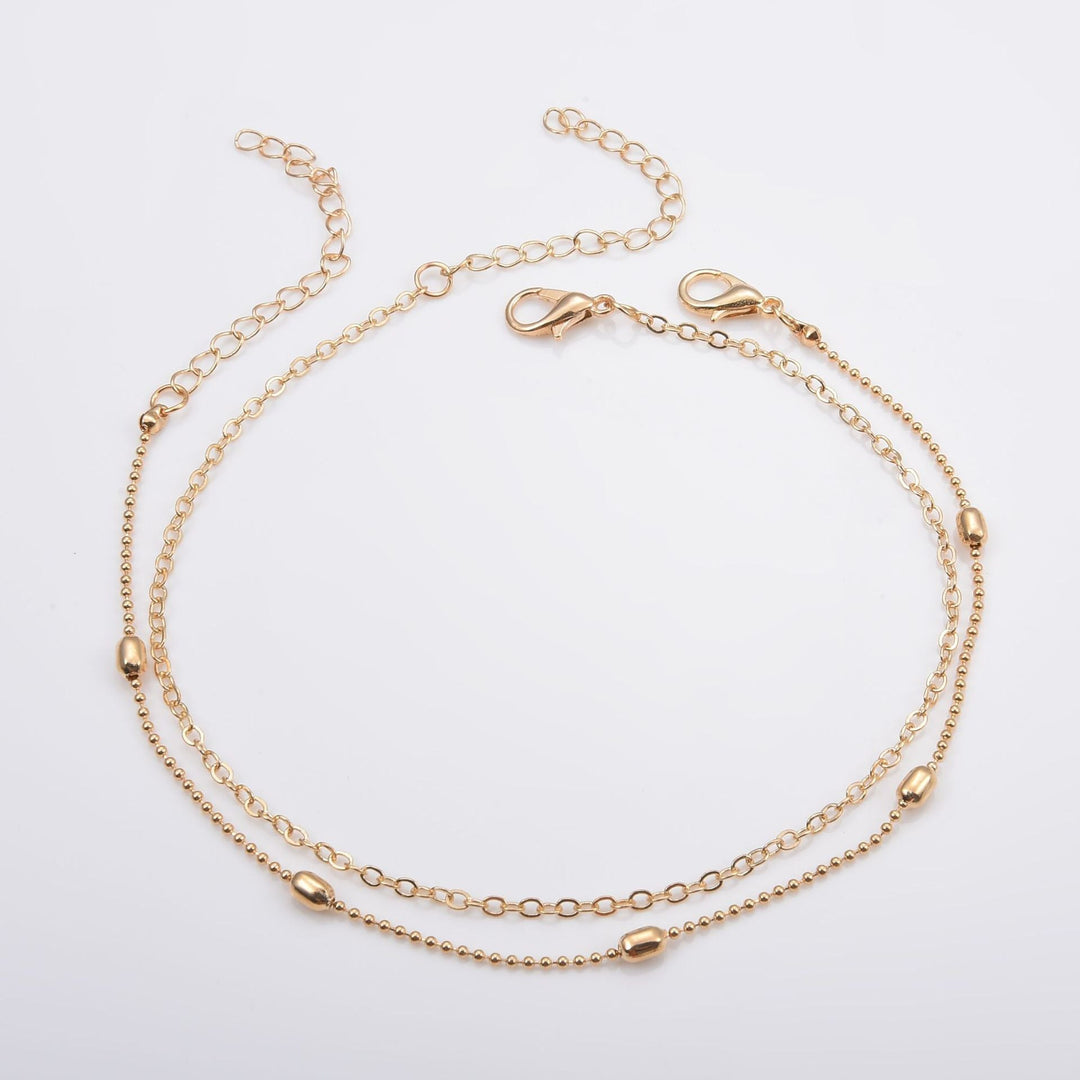 Elegant adjustable layered gold chain anklet, a chic women's foot jewelry & fashion accessory.