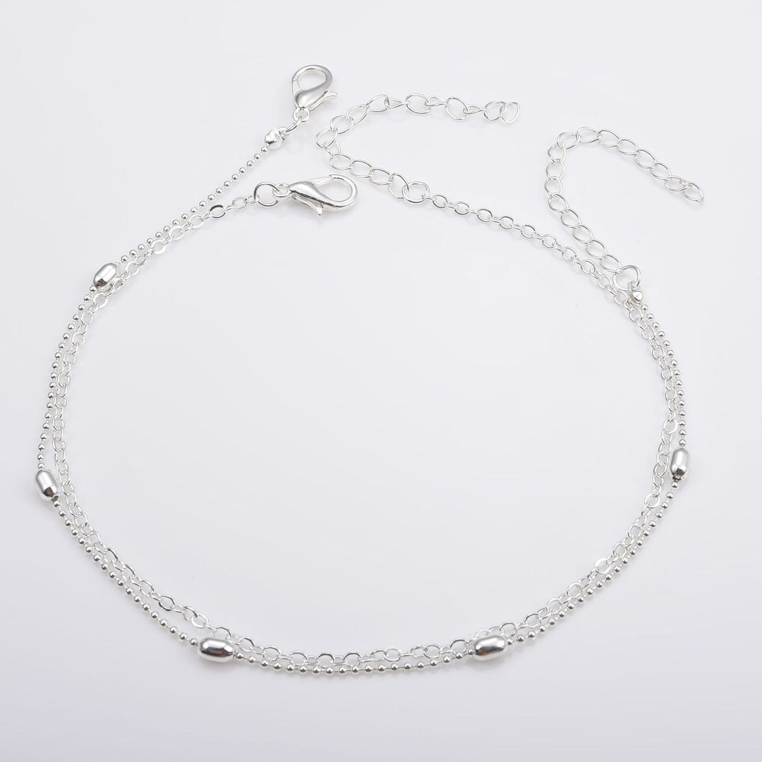 Stylish white layered chain anklet for women, a delicate summer foot jewelry accessory.