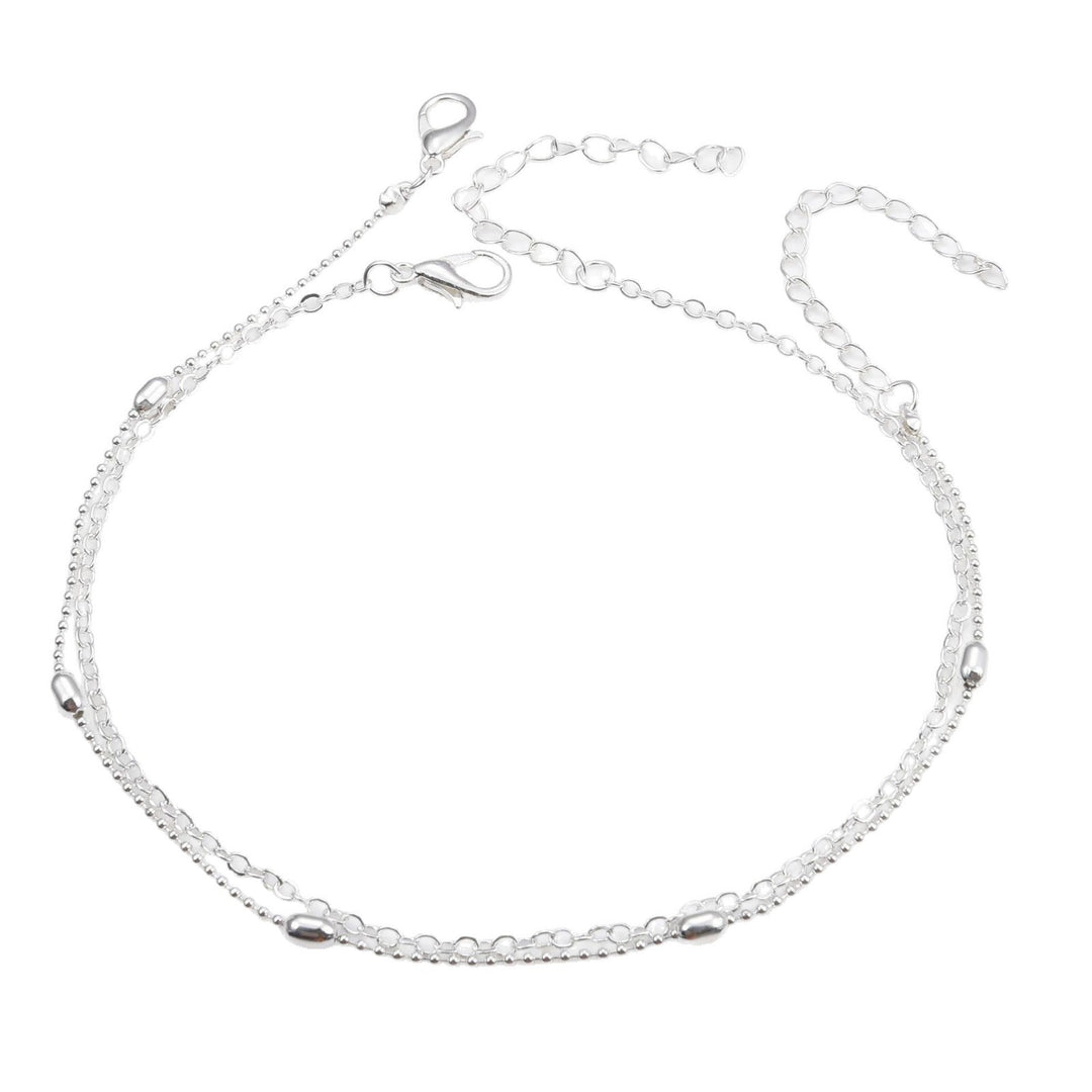 Gold tone delicate layered chain anklet, women's elegant foot jewelry for summer fashion.
