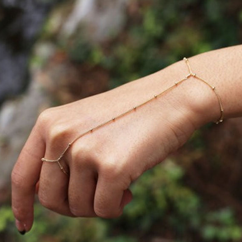 Elegant gold and white chain ankle bracelet for women, an adjustable delicate summer fashion accessory.