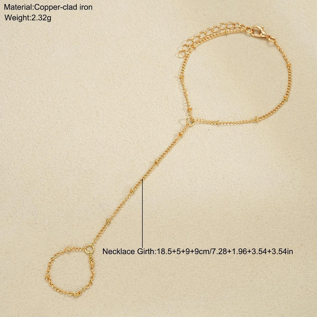 Women's adjustable gold and white chain ankle bracelet, a stylish delicate summer jewelry accessory.
