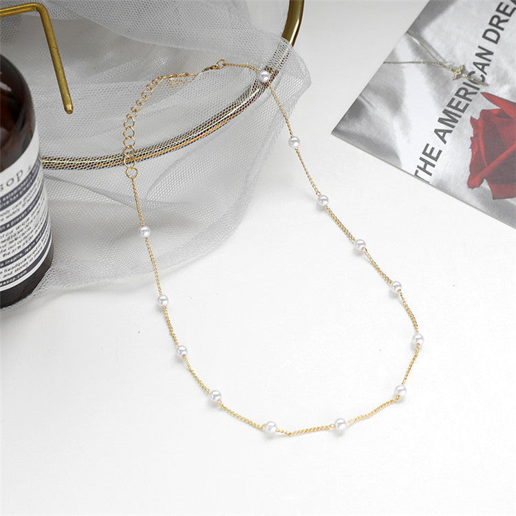 Fashionable women's delicate pearl necklace, a charming gold chain accessory and gift for her.