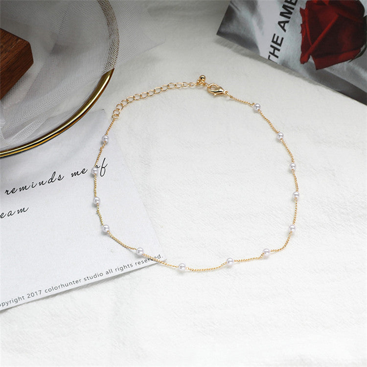 Beautiful women's delicate pearl and gold chain necklace, a timeless and elegant fashion accessory.