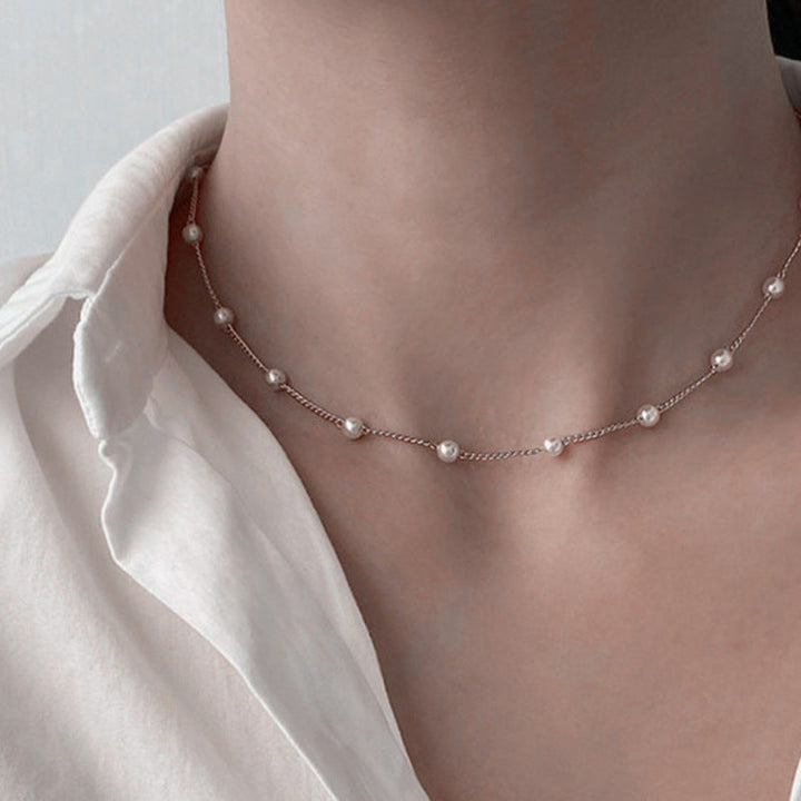 Gift for her: elegant delicate white pearl necklace on a fine gold chain, a sophisticated women's accessory.