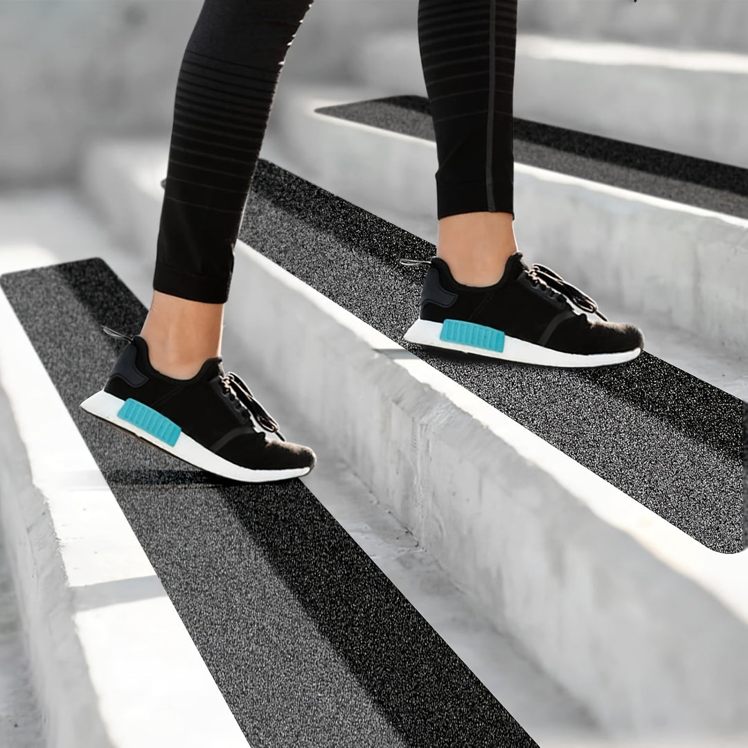 Black rubber non-slip tread strips for enhanced grip on stairs & driveways, increasing safety & preventing slips.
