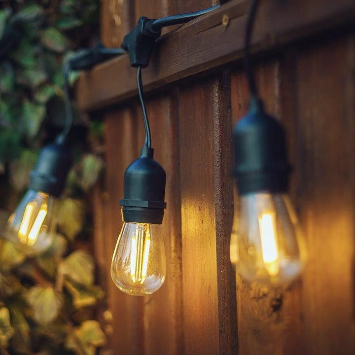 Warm white LED string lights for enchanting patio & garden ambiance, connectable for custom lengths.