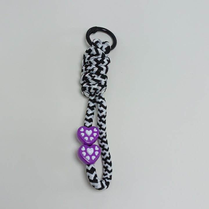 Paracord key holder with integrated survival features for outdoor enthusiasts & daily use.