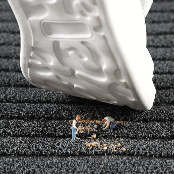 Gray weatherproof non-slip outdoor entryway mat. Durable and washable floor rug for front doors and patios.