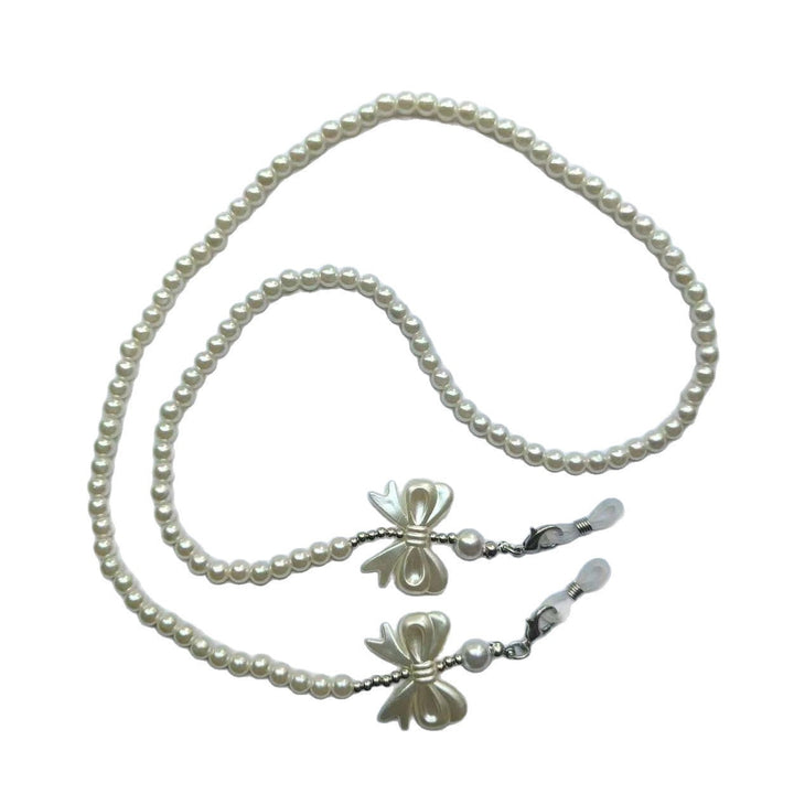 Close-up: Elegant 30-inch pearl glasses holder chain for women, highlighting lustrous pearls and bow.